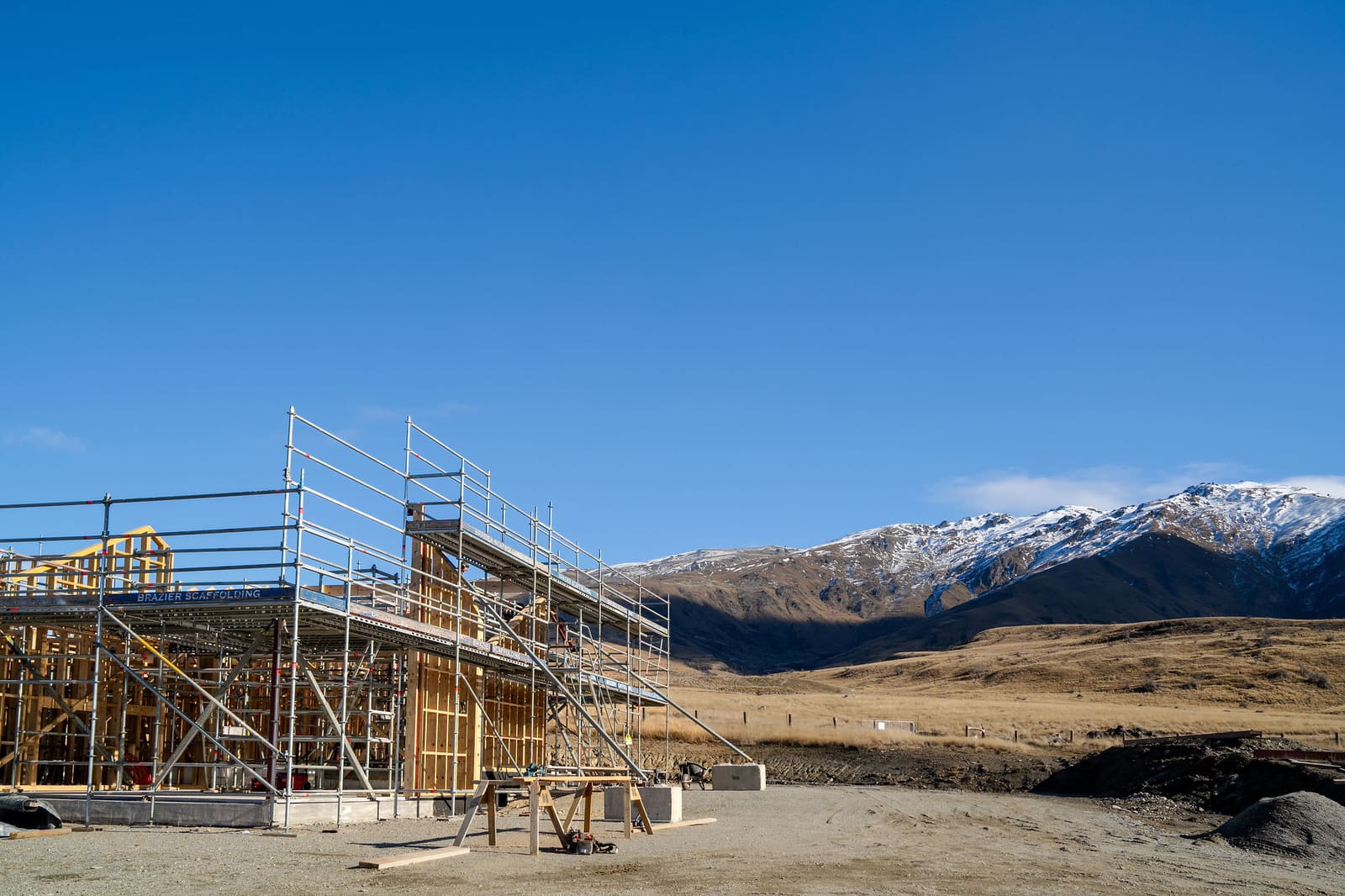 Scaffolding on a building site below mountains in New Zealand