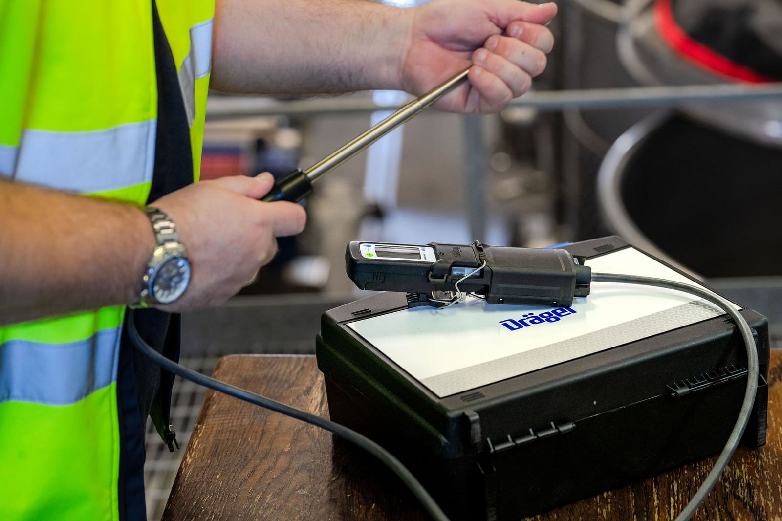 Worker operating a direct-reading gas detector