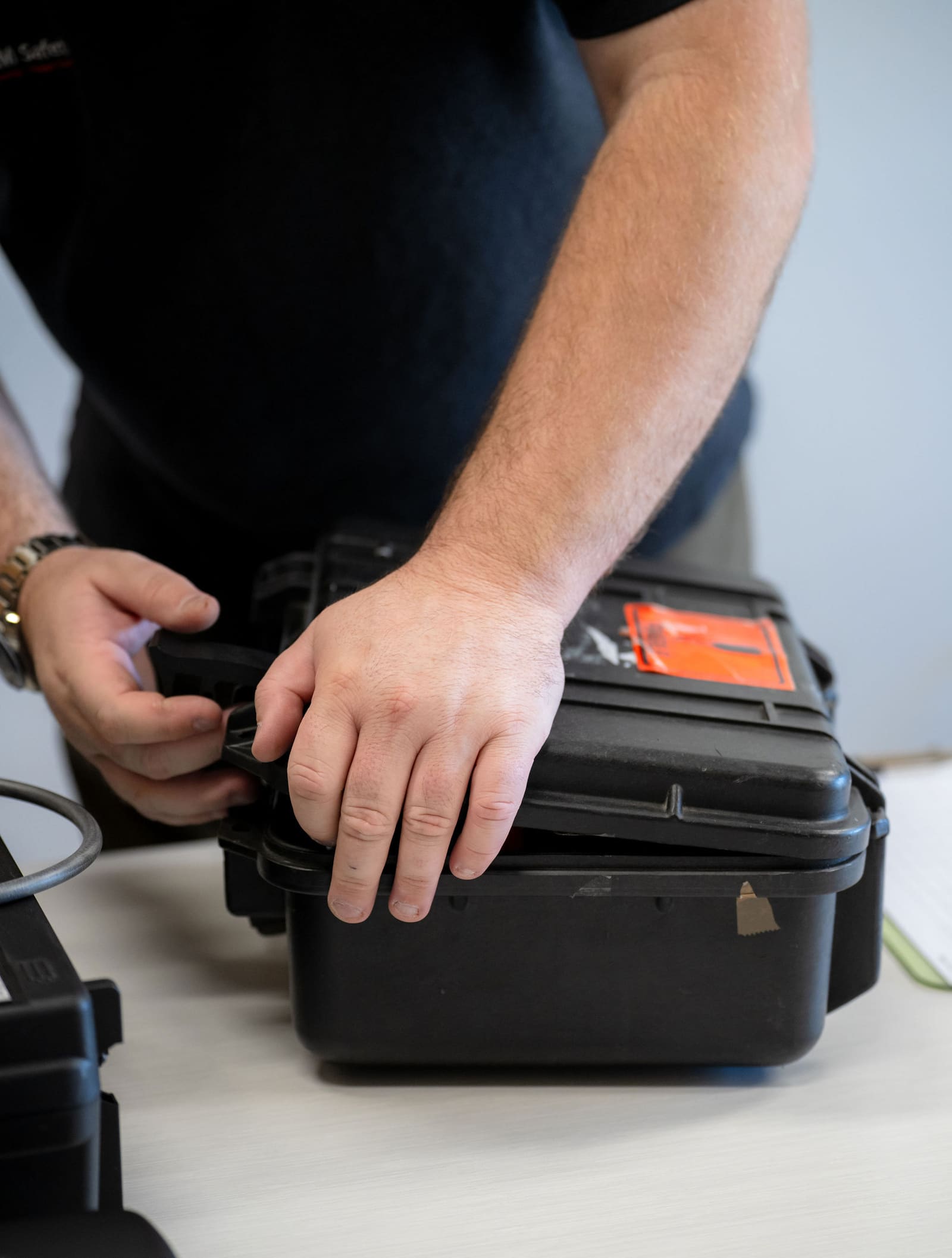 Hands closing an equipment case