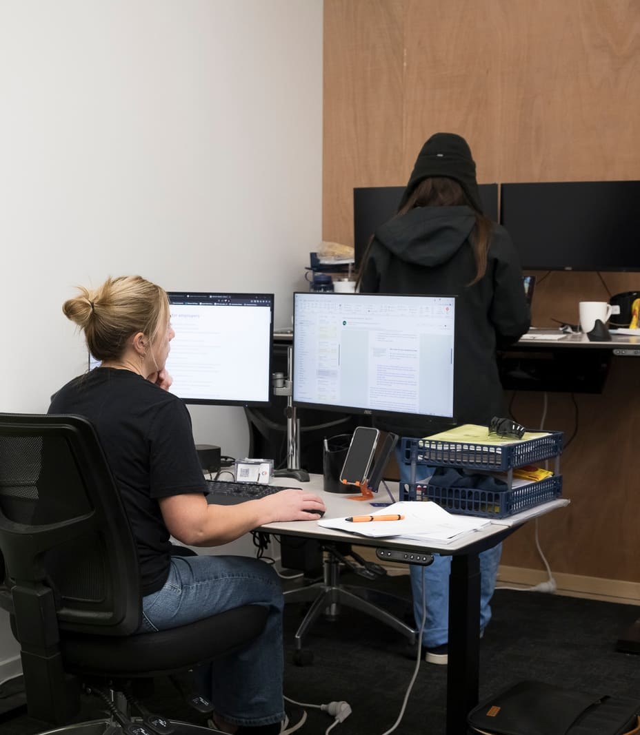 A hygienist and developer reviewing data together at a workstation
