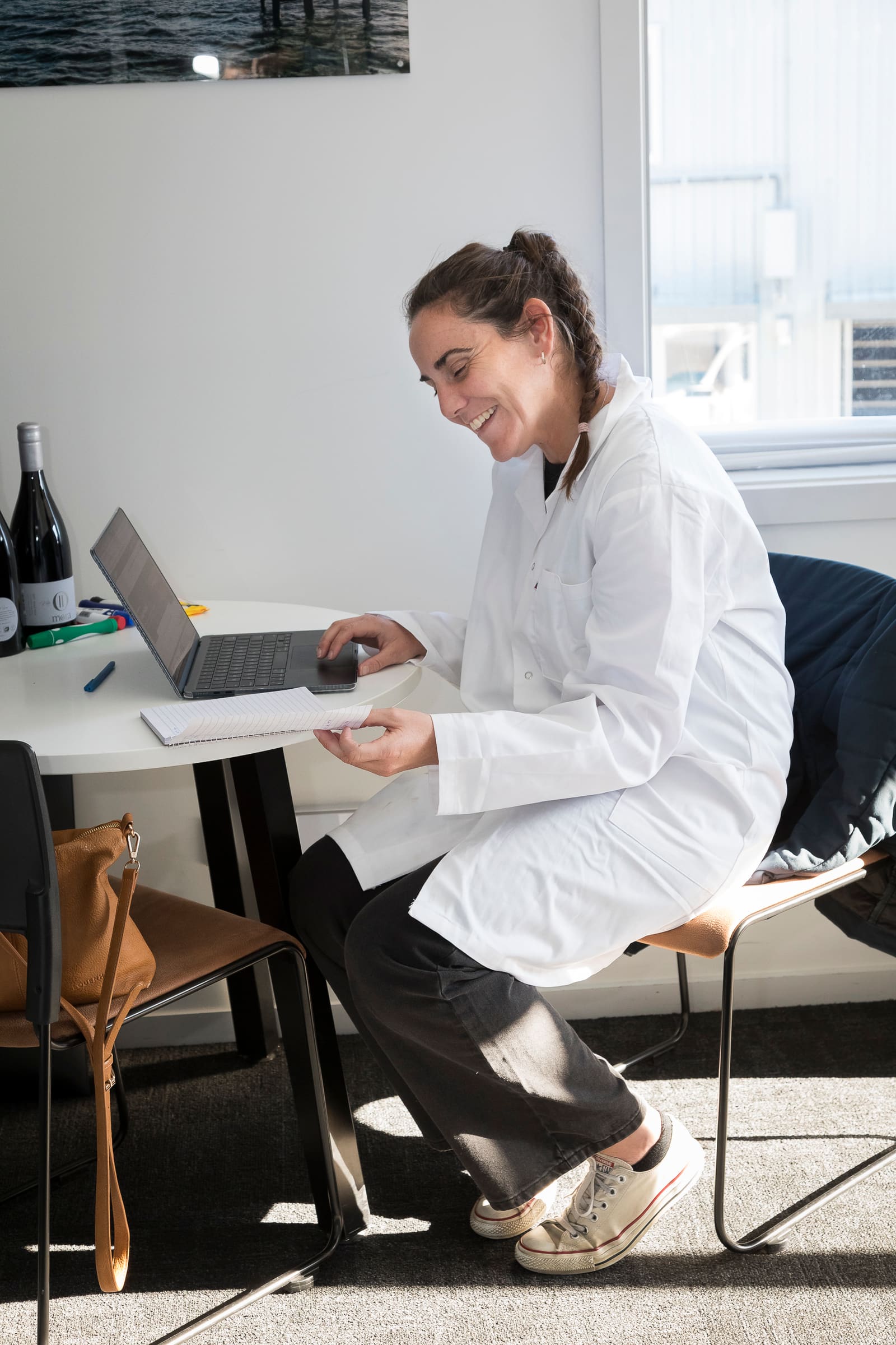 Laboratory analyst working through sample results on a laptop