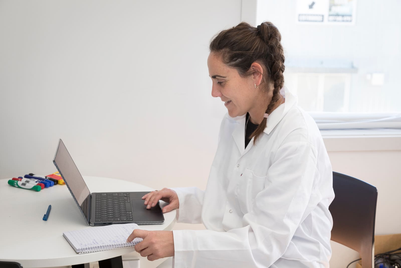 Laboratory analyst reviewing exposure data on a laptop
