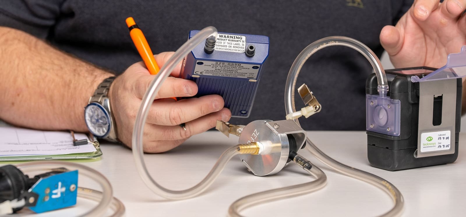 Sampling pump flow being calibrated with a flow meter