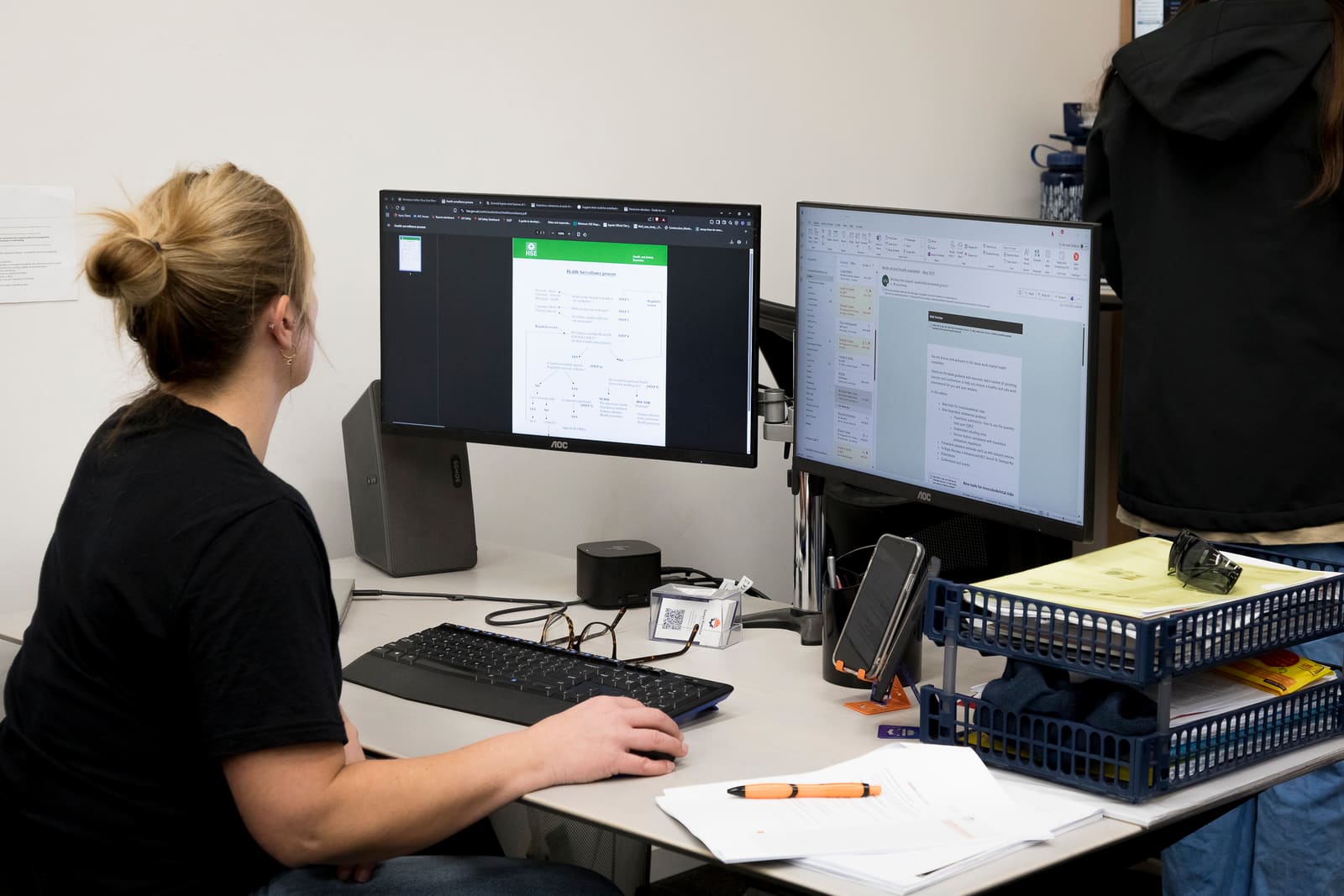 Coordinator reviewing contractor documents on screen