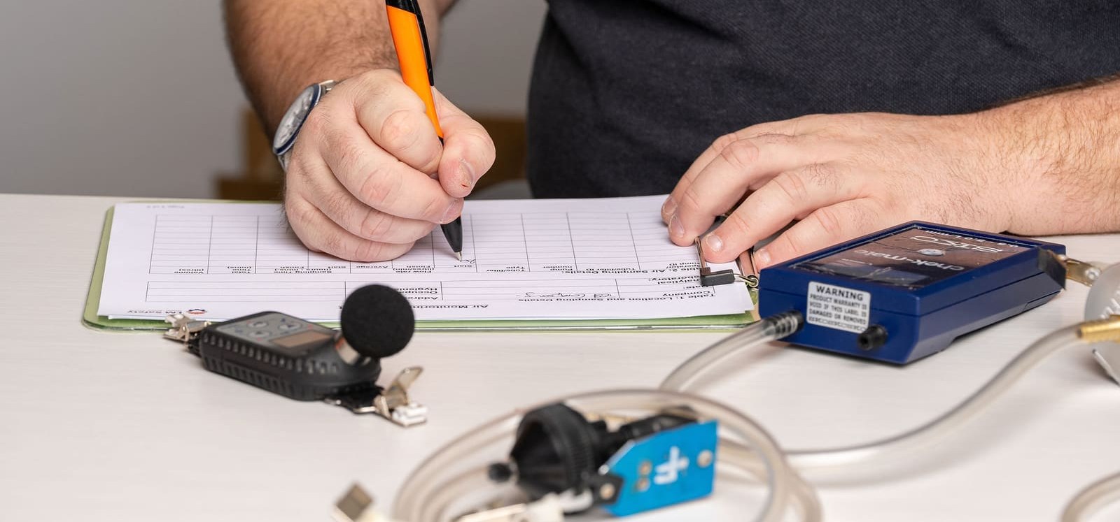 Technician recording a pump calibration on a form
