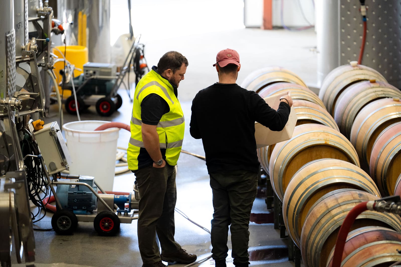 Two people walking through an industrial site discussing work